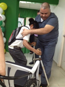 A young recipient is helped to receive her wheelchair